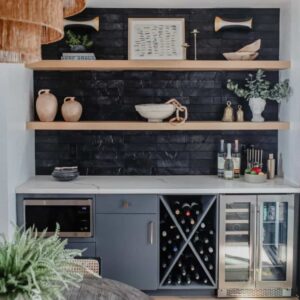 Modern kitchen shelving with decorative tile backsplash and cabinetry.