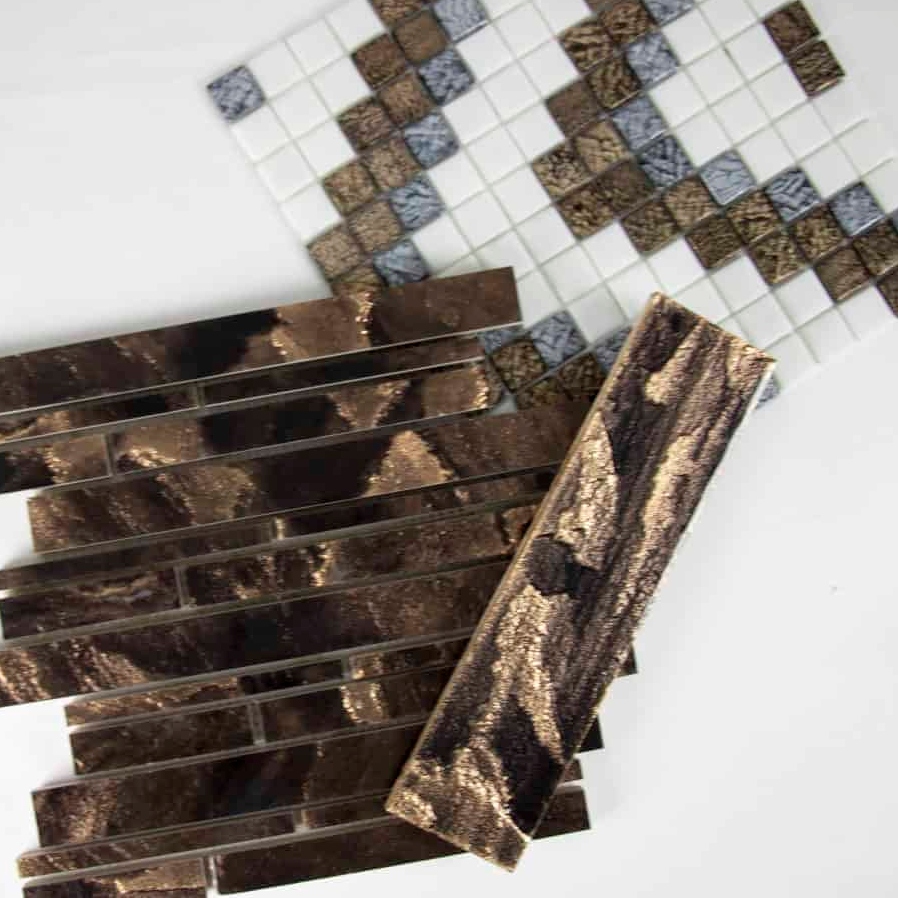 A collection of various tile samples in brown and blue tones, showcasing different textures and patterns on a white background.