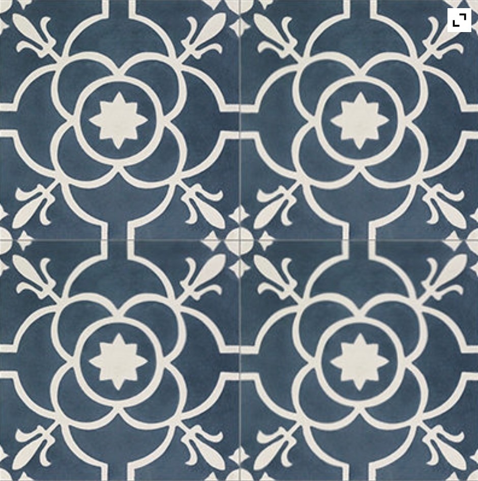 A pattern of floral motifs in white on a dark blue background, arranged in a symmetrical design.