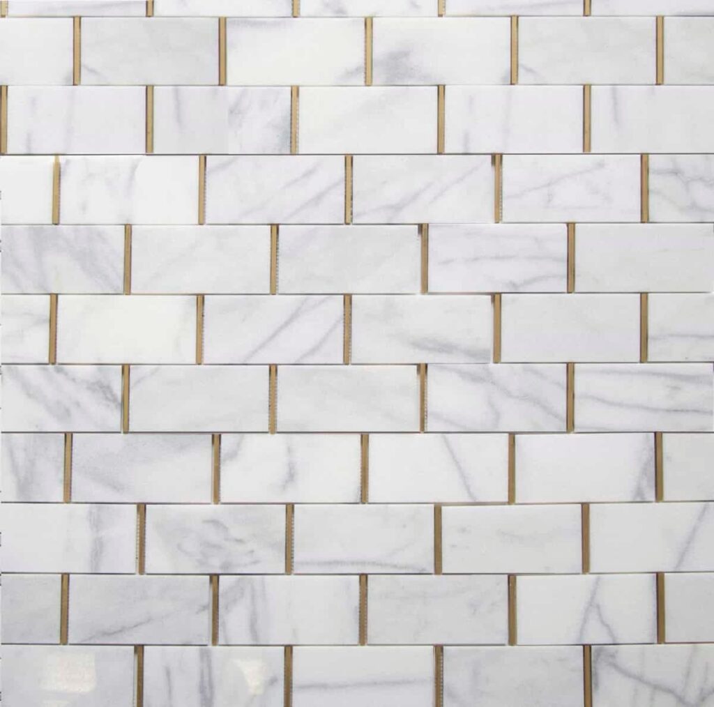 A textured wall featuring white marble tiles arranged in a staggered brick pattern with thin gold grout lines.