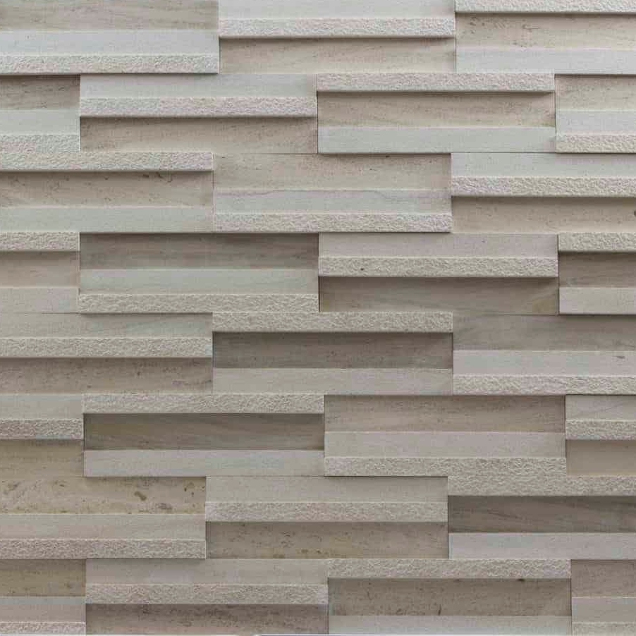 A textured wall consisting of rectangular wooden panels arranged in a staggered pattern, showcasing light wood tones.