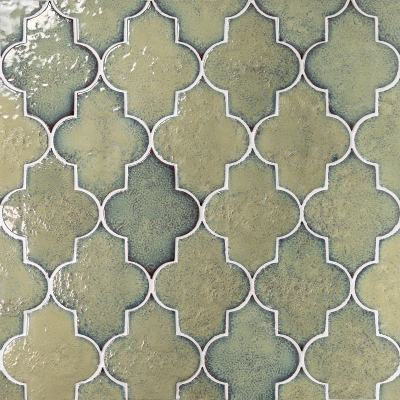 Intricate tile design featuring a repeating pattern of interconnected geometric shapes in muted greens and blues.
