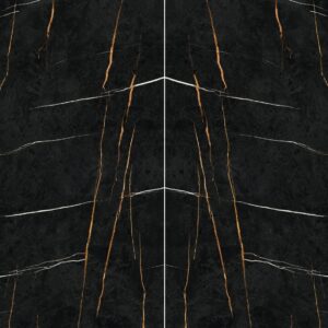 A symmetrical marble surface with rich black tones accented by prominent golden and white veining.