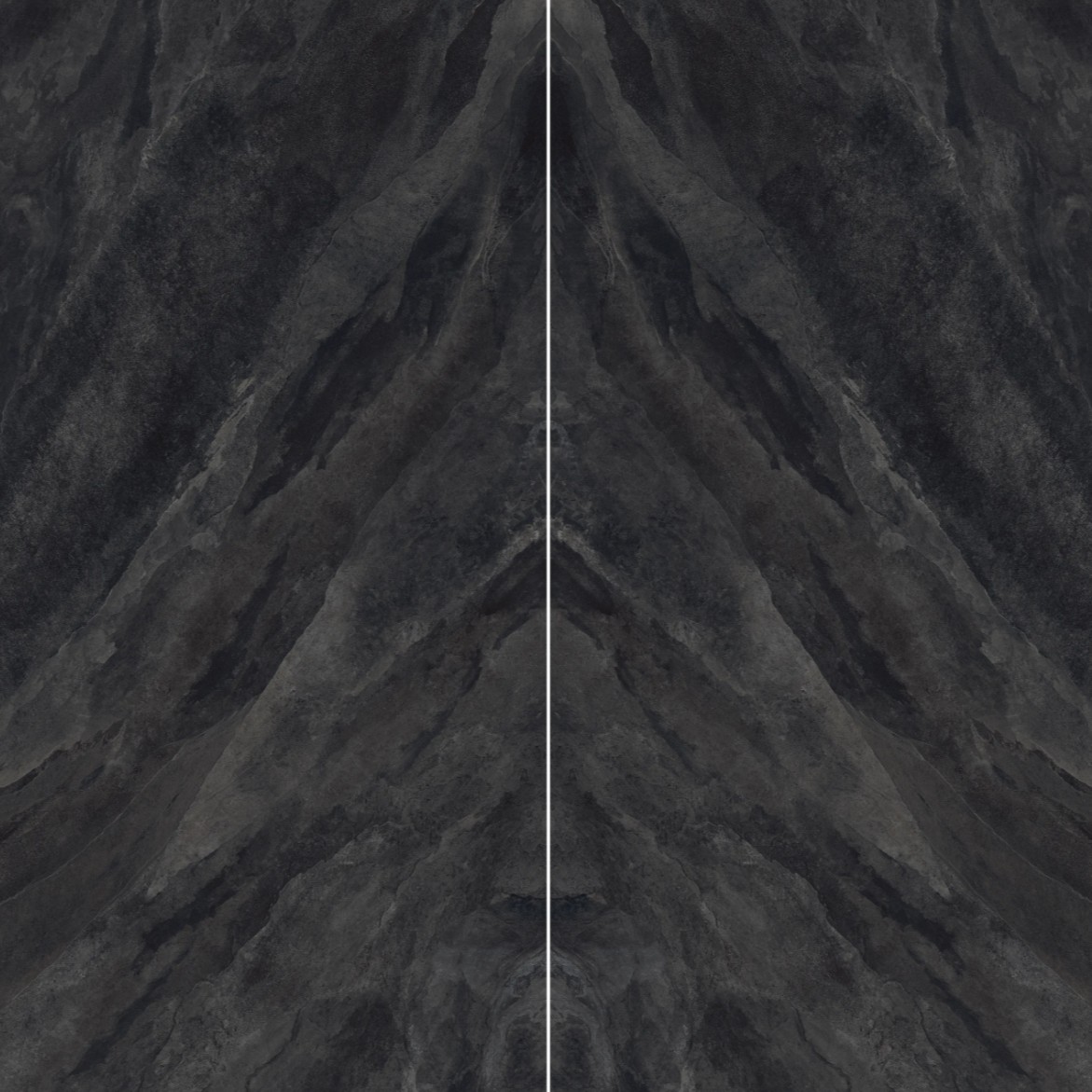 A textured dark surface showcasing swirling patterns in shades of grey and black, resembling natural stone or abstract art.