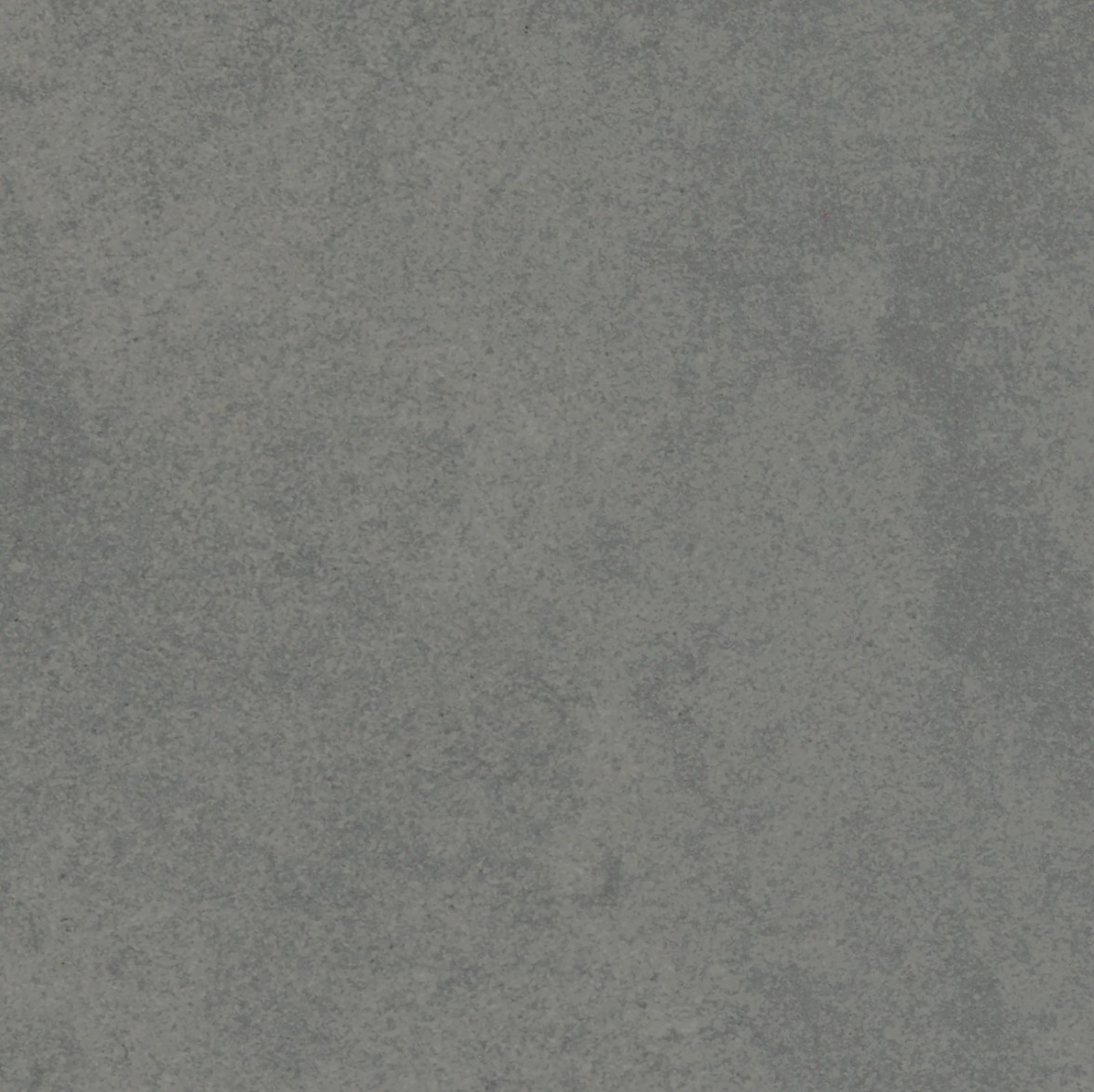A textured surface with a uniform gray color, exhibiting subtle variations in tone and a smooth, matte finish.