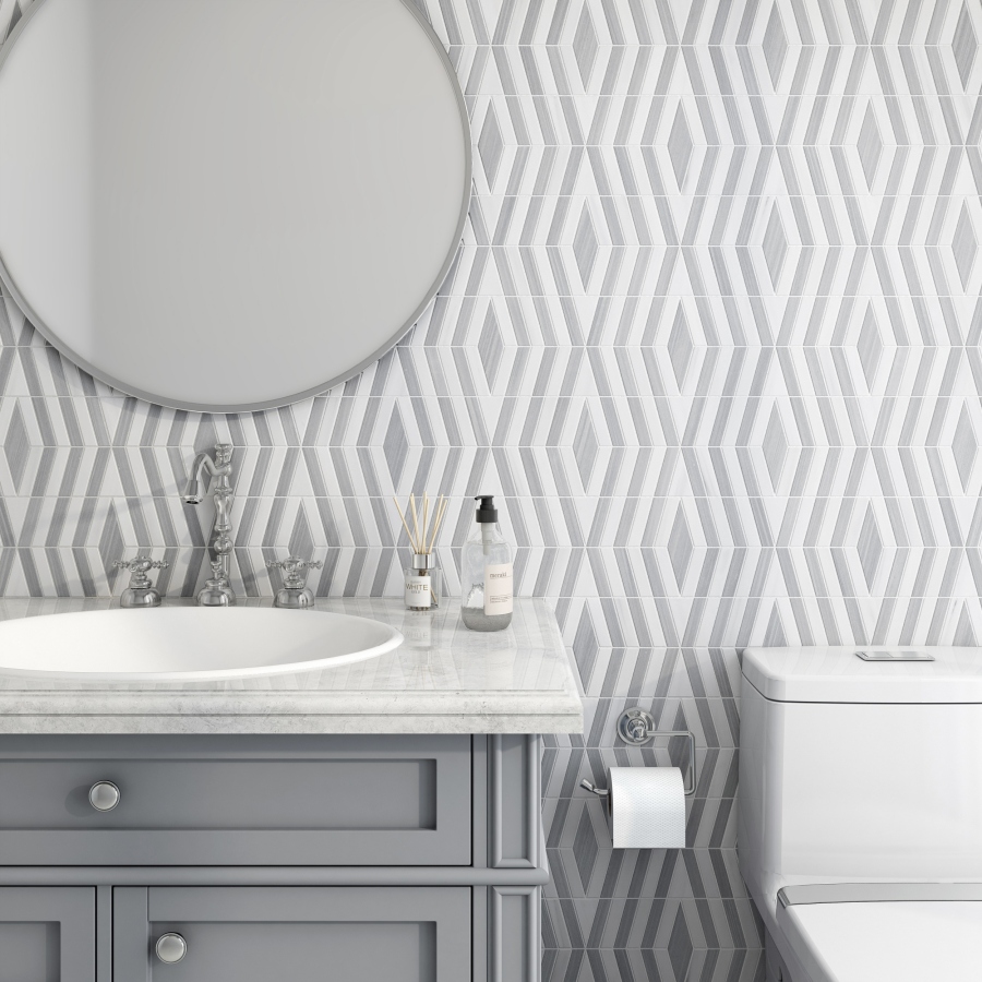 A modern bathroom features a circular mirror, a sleek vanity with a marble countertop, and geometric patterned walls.