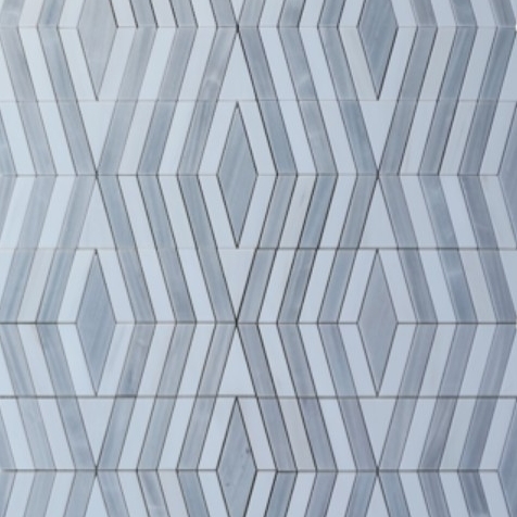 A geometric pattern composed of gray and white tiles arranged in a diamond and zigzag design, creating a modern, textured appearance.