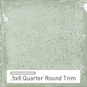 A smooth, light green tile with a speckled texture, labeled as .5x8 Quarter Round Trim.