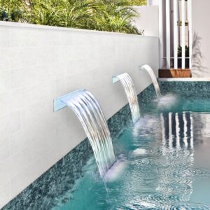 Three modern waterfalls pouring into a turquoise pool, surrounded by lush greenery and a sleek white wall.